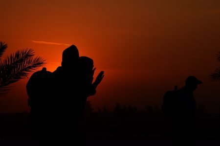 Iraq dawn landscape with silhouettes of morning prayer.