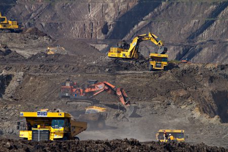 A number of digging trucks working in a mine.